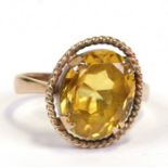 A Scottish 9ct gold dress ring set with a large oval yellow stone, possibly citrine, approx UK