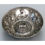 An Ottoman white metal bowl decorated in relief with animals and having a central recumbent stag,