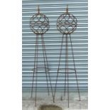 A pair of spherical iron garden obelisks on stands, 163cms (64ins) high (2).