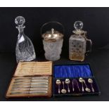 A boxed set of six silver Apostles spoons and sugar tongs; together with a frosted glass biscuit