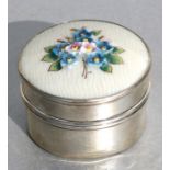 A George V silver circular pill box, the cover with floral enamel decoration, Birmingham 1925,