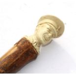 An unusual WW2 Welsh Guards walking stick with a cream plastic head and shoulders top. Having the