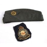 A 1945 dated RAF side cap with original brass cap badge and buttons. Printed inside: L