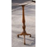 A mahogany torchere, the turned column above a tripod base, 107cms (42ins) high.