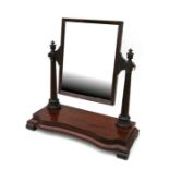 A 19th century mahogany swing frame toilet mirror with a rectangular plate on column supports and