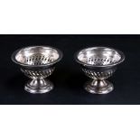 A pair of silver plated pedestal bon bon dishes with pierced decoration, 10cms (4ins) diameter (2).