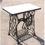 A cast iron sewing machine base enamel topped garden table, 77cms (30ins) wide.