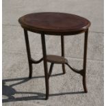 An Edwardian oval mahogany two-tier occasional table, 67cms (26.5ins) wide.
