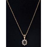 A 9ct gold and sapphire pendant on a 9ct gold chain,