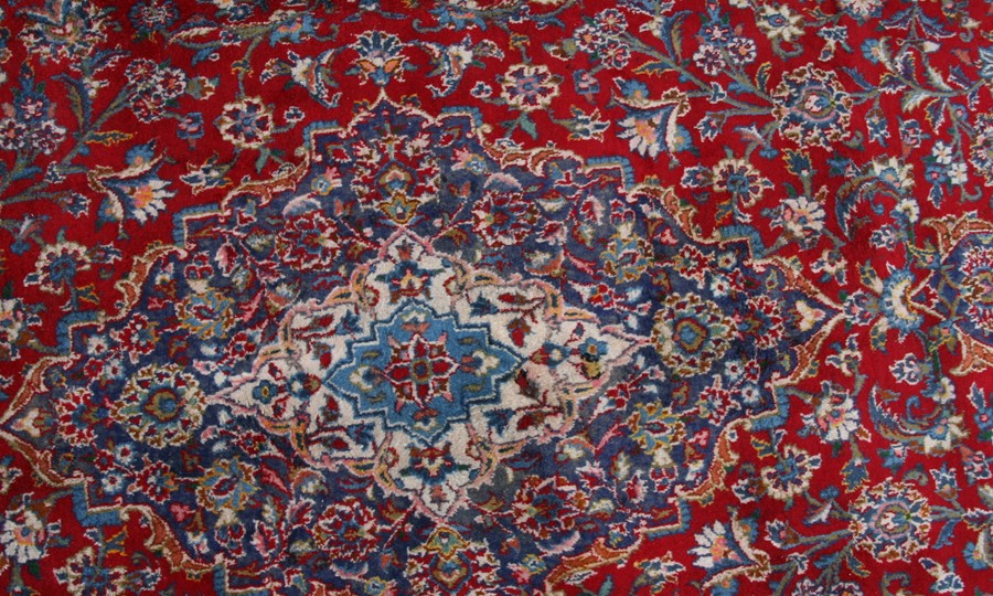 A Persian Mashad woollen hand knotted carpet with central floral medallion within floral borders - Image 2 of 2