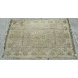 A Persian rug with central medallion on a beige ground, 124 by 188cms (49 by 74ins).