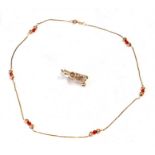 A 9ct gold and coral bead necklace; together with a yellow coloured metal charm in the form of a