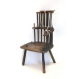An early elm stick back country armchair (a/f).Condition Report86cms high, 52cms width of seat and
