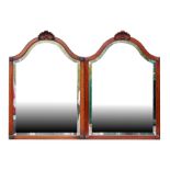 A pair of mahogany framed shaped bevel edged wall mirrors, each 70 by 100cms (27.5 by 39ins) (2).