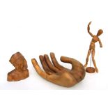 A treen carved fruit bowl in the form of a hand, 35cms (14ins) diameter; together with an artist's