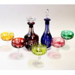 Two Bohemian flashed glass decanters; together with five flashed glass champagne glasses (7).