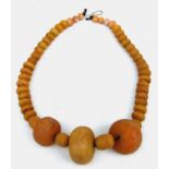 An ethnic graduated amber / amber like bead necklace.