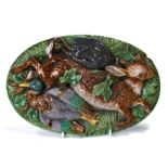 A majolica oval wall plaque decorated in relief with dead game (probably Minton), 27 by 18cms (10.