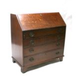 A 19th century oak bureau, the fall front revealing a fitted interior above one short and three long