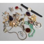 A quantity of costume jewellery to include brooches, pendants and necklaces.