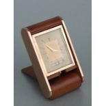 A Le Coultre folding leather calendar travel alarm clock. 13cm (5 ins) highCondition ReportSeems