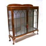 A walnut two-door glazed display cabinet, 121cms (47.5ins) wide.