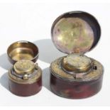 A Victorian brass travelling inkwell in a leather case, 7cms (3.75ins) wide; together with another