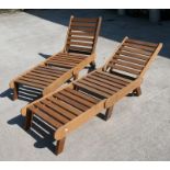 A pair of bespoke hand made hardwood sun loungers with adjustable backs, 203cms (6ft 8ins) fully