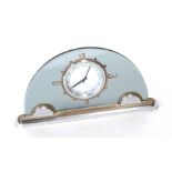 An Art Deco Le Coutre desk clock, half moon grey glass with chrome and silver plated base, 25cms (