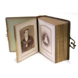 A Victorian tooled leather cabinet photo album containing portraits including a gentleman in Mason's