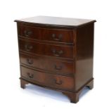 A reproduction figured mahogany bowfront chest of four graduated long drawers, on bracket feet,