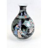 A Chinese famille noir vase decorated with figures in a landscape, six character mark to the