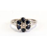 A 9ct gold white gold sapphire and diamond flower head ring, approx UK size 'M'.