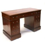 A late 19th / early 20th century mahogany pedestal desk with an arrangement of nine drawers, on a