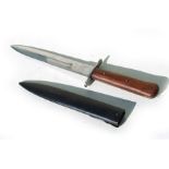 A WW2 double edged fighting knife in its metal scabbard. Blade length 17.5cms (6.875ins)