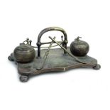 An Edwardian silver plated pen & ink stand, the two inkwells in the form of curling stones, 24cms