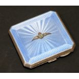 RAF interest. A silver & blue guilloche enamel compact with applied silver & enamel RAF wings,