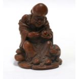 A Chinese carved bamboo figure depicting a seated robed man holding a gourd. 14cm (5.5 ins) high