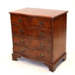 A reproduction burr walnut serpentine chest of two short and three graduated long drawers, on