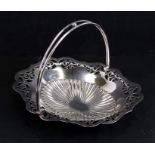 A George III style silver plated swing-handle bread basket with pierced decoration, on ball feet,