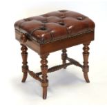 A late 19th century walnut rise-and-fall piano stool with button upholstered leather seat.