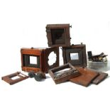 A quantity of Victorian mahogany plate camera parts and lenses.