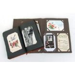 Two early 20th century postcard albums containing topographical, whimsical, silks and other cards (