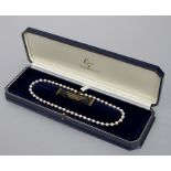 A Lotus freshwater cultured pearl necklace with 9ct gold clasp, cased.