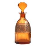 An early 20th century Moser amber glass scent bottle decorated with an oroplastic gilt frieze of