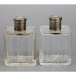 A pair of Edwardian glass and silver capped scent bottles, marks rubbed, 10cms (4ins) high (2).