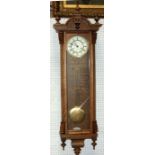 A Vienna style oak cased wall clock 1425cm (49 ins) high
