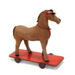 A vintage pull-along horse, 63cms (25ins) wide.