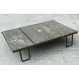 An industrial style painted metal and wooden low table, 107cms (42ins) wide.