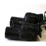 A pair of British military Avimo 7x42 autofocus binoculars with rubber protective casing.